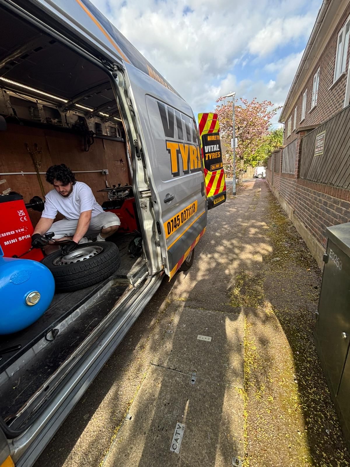 Vital Tyres fitter changing a tyre roadside